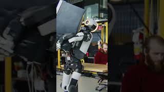 Humanoid robots lifting, balancing, and maneuvering large household appliances