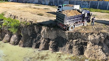Unbelievable dump trucks unloading soil and bulldozer pushing soil into water 