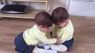 Twin baby girls fighting for car keys