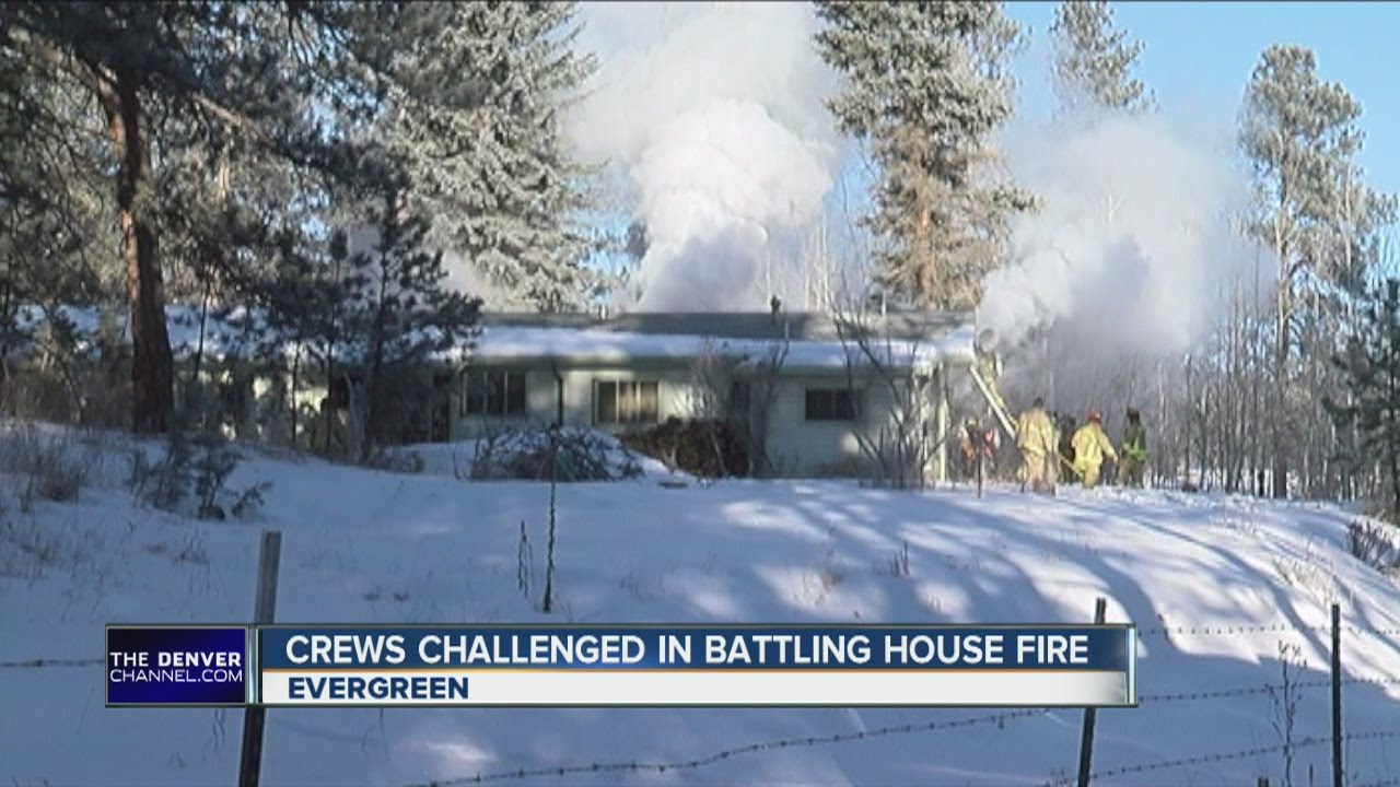 Crews challenged in battling house fire - YouTube