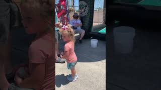 Little girl throws baseball that hits fair attendant on sensitive area (woodies)