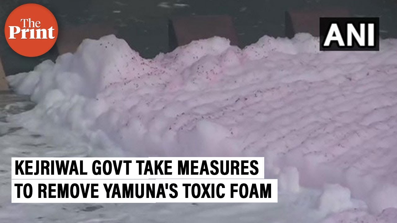 Delhi Jal Board employees sprinkle water in Yamuna to remove toxic foam