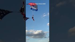 Golden Eagles paratrooper lands closeup at Plano balloon fest 2023. Parachute