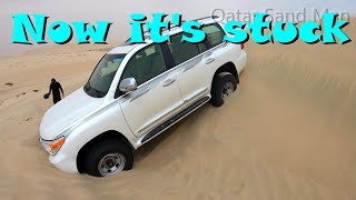Toyota Land  Cruiser stuck in sand hollow on high sand dunes Qatar desert, Sealine Beach Inland Sea
