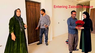Reza and his second wife entering Zeinab's house