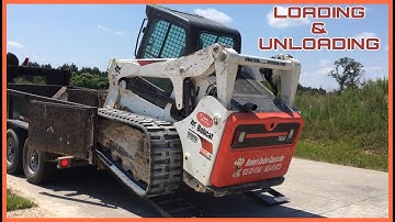 Loading and unloading bobcat T650 skid steer cab view