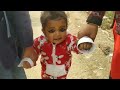 Battu walking with his mom and sister and uncle