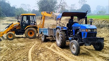 JCB 3dx Backhoe loading soil in Eicher 380 Super plus Tractor Trolley