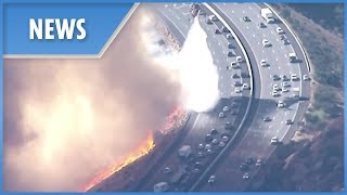 In this video, firefighting helicopters can be seen expertly dumping
gallons of water just metres away from fleeing motorists. the
encroaching fire was creep...