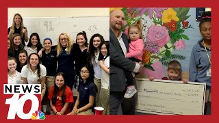 Husband of late Mercy teacher presents $60,000 check for memorial scholarship