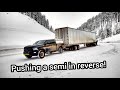 Ram truck pushes semi up a mountain in reverse!