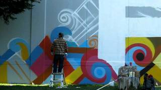 Graffiti Artist Reyes painting 'Familia' off Ceaser Chavez in San Francisco June 2011
