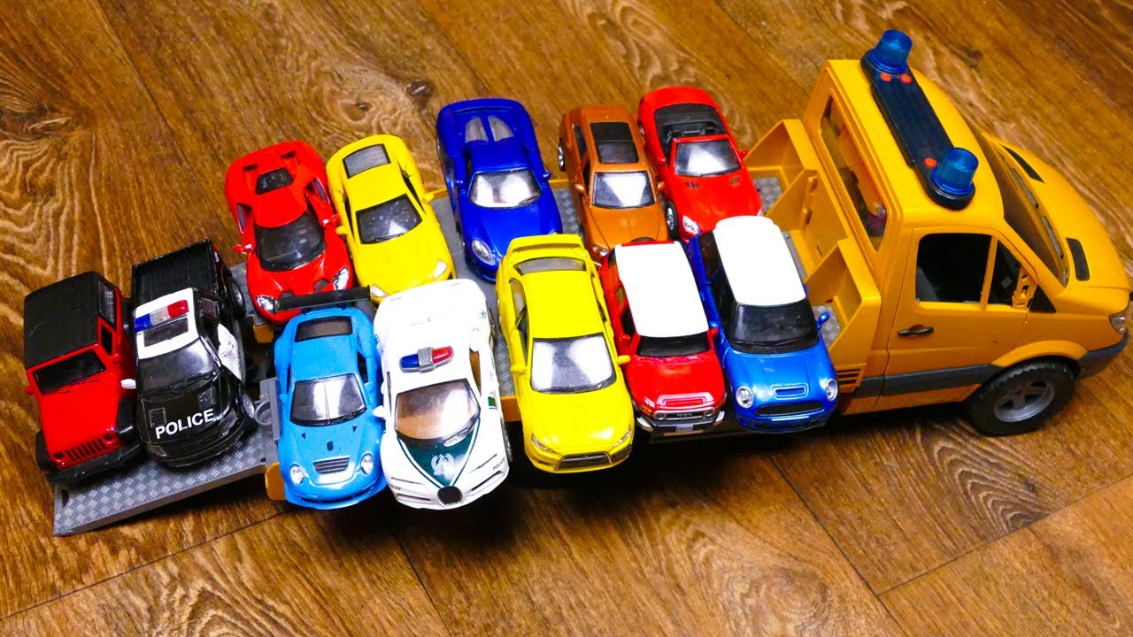 Lot Of Various Bigger And Smaller Die Cast Model Cars on Big Tow Truck