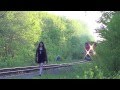 Strange Ottawa Girl walks along tracks on CN RAIL as a train approaches.