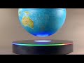 Large floating globe with multi color interactive base