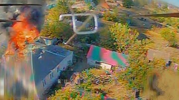 FPV Drone Captures Artillery Shell Hitting Burning House With Russian troops.