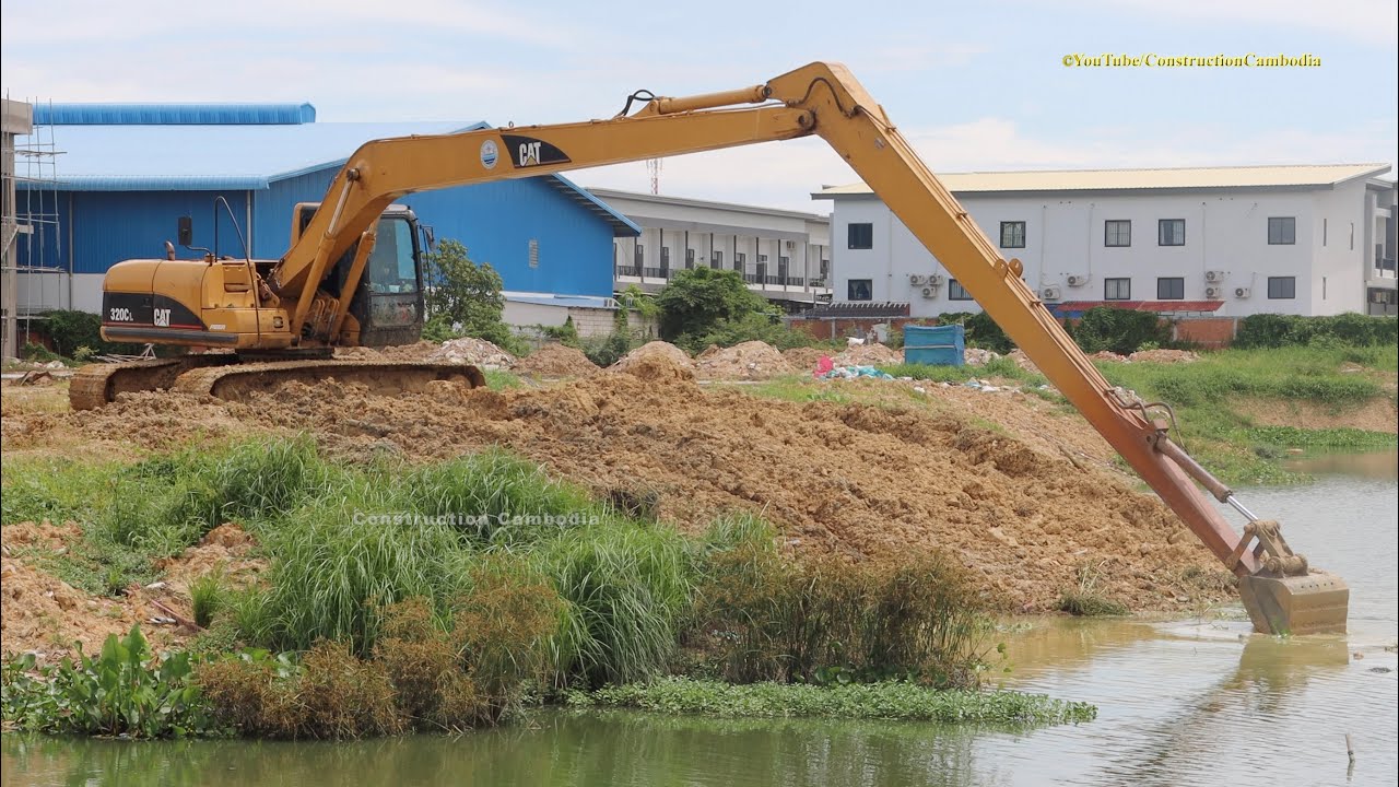 CAT 320LC Long Reach Excavator Digging Clearing Mud From Canal - YouTube