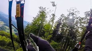 Beginner paraglider without helmet crashes into the trees