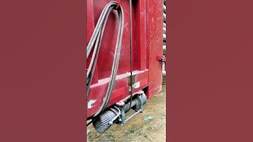 Red Truck Electric Winch Operation: Full View of Rope Reel Process