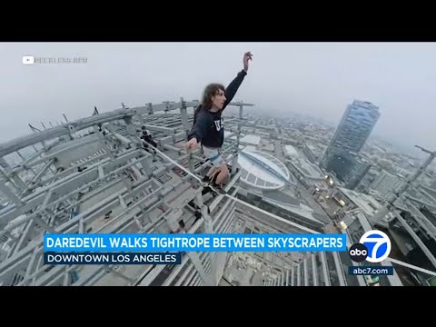 Daredevil walks tightrope between graffitied skyscrapers in downtown LA