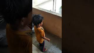 Baby playing in rain.  kiyan palying in rain. baby enjoying rain