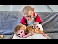 Yiyi helps take care of baby monkey while grandpa cooks for her