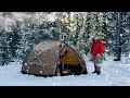 Winter hot tent camping caught in unexpected snowstorm in the oregon forest