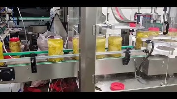 Fully automatic four-head film sealing machine and servo claw capping machine.