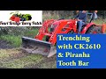 Kioti CK2610 and Piranha Tooth Bar Digging drainage ditch for corrugated pipe