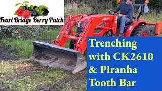 Kioti CK2610 and Piranha Tooth Bar Digging drainage ditch for corrugated pipe