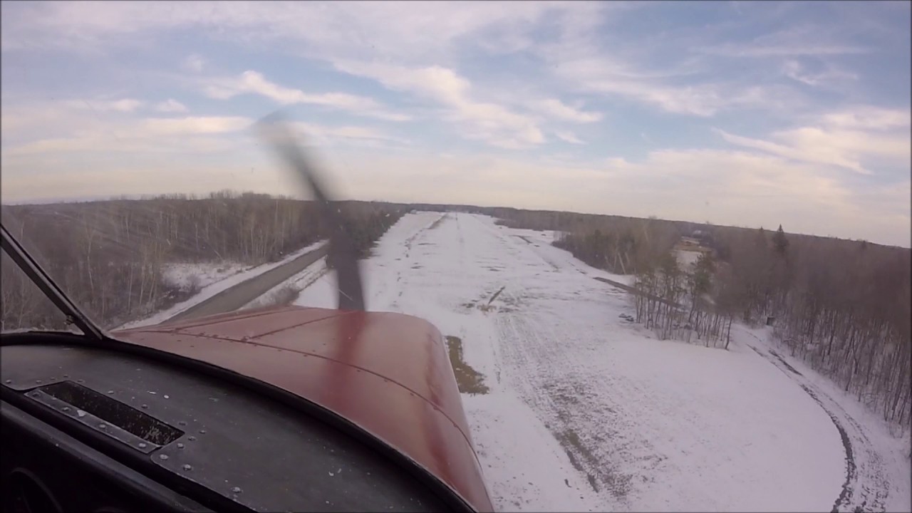 Landing a Cessna 170 on a grass runway covered with snow - YouTube