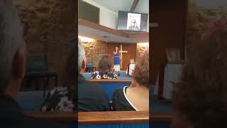 Emerson singing at Sherene's funeral