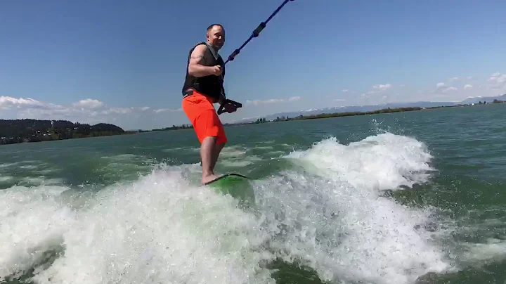 Jason trying out wake surfing behind his new boat