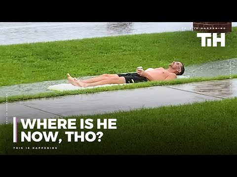 Guy Slides on Flooded Pavement While Lying on Pool Float