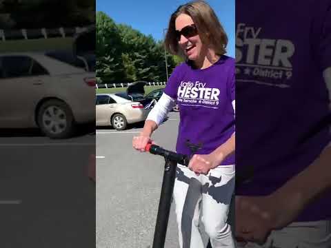 Senator Hester on the scooter, outside Centennial Lane Elementary School