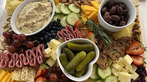Assembling a charcuterie board with food influence...