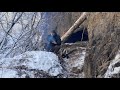 Secret shelter built under an earthy cliff during winter at 20c  solo survival
