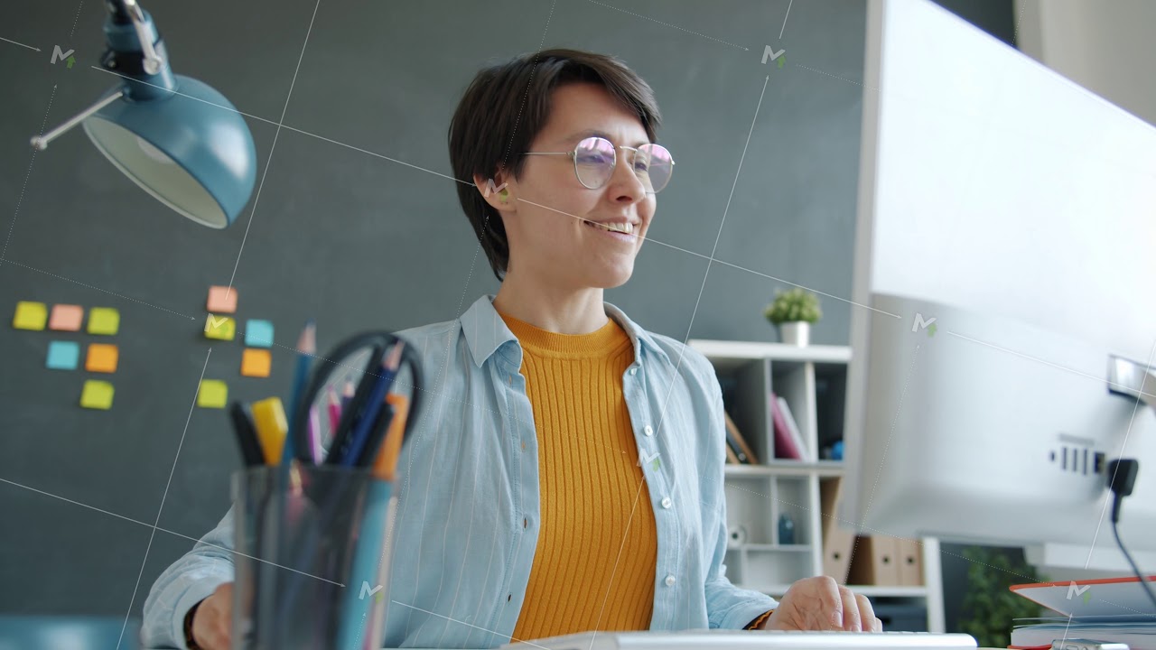 Office worker smiling enjoying good news looking at computer screen at work