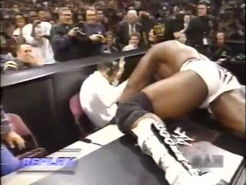 Booker T pukes on Micheal Cole after a stinkface from Rikishi