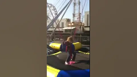 Erin jumping at Milford mall carnival