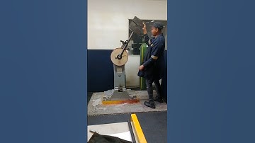 QUICK SWING & DROP OF HEAVY MANUAL HAMMER IN PERFORMING CHARPY IMPACT RESILIENCE TEST IN LABORATORY