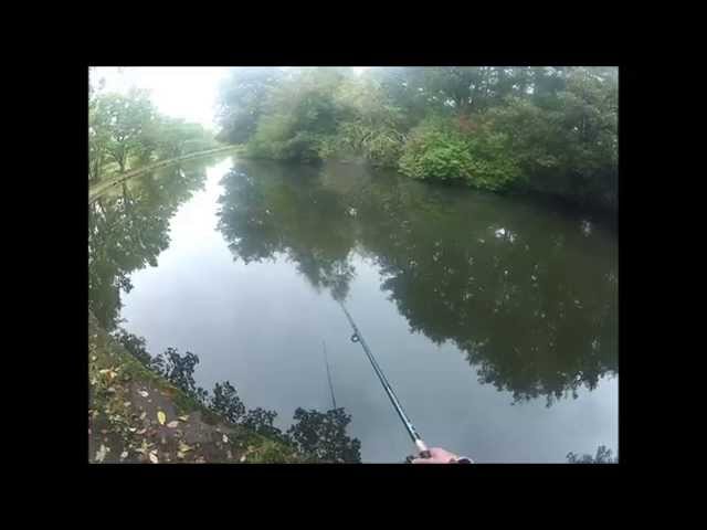 Man fishing with rod & reel, on the Bridgewater Canal - Leigh