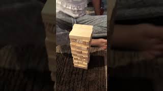 Playing Jenga with his sister