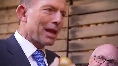 Tony Abbott eats a raw onion