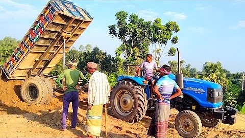 River soil unloading from tractor unload over rough hills through digital hydraulic system facility