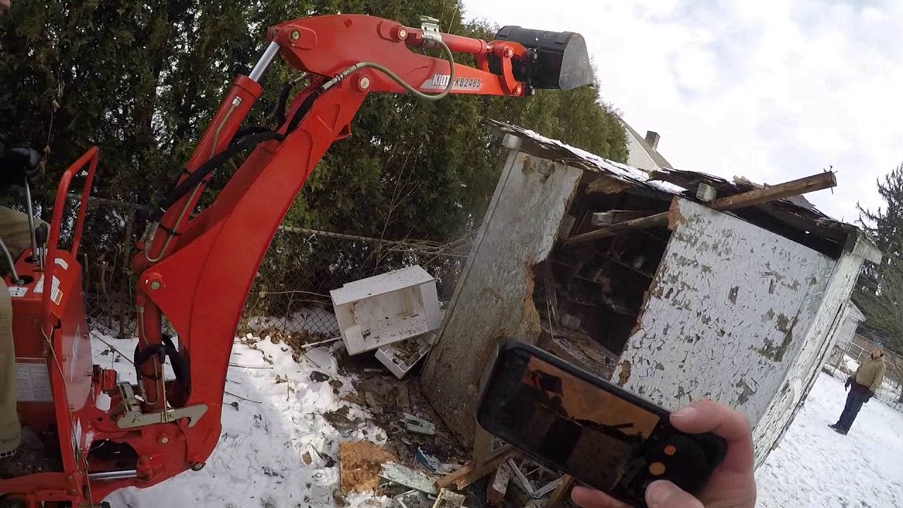 Smashing shed destruction demolition with a tractor