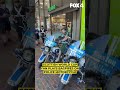 Scottish soccer fans play bagpipes on police motorcycle