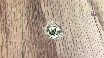 Installing threaded inserts into a wood table top.