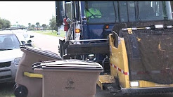 Trash company refusing to pay fines over automated pickup service