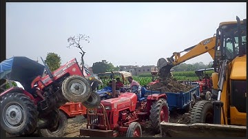 JCB 3 DX Backhoe Loading Soil in Mahindra 265 Trakstar tractor and Massey Ferguson 241 DI Trolley